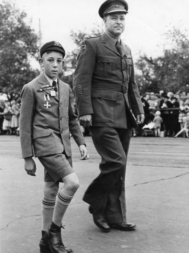 David Matthews as a child wearing his father Captain Lionel Matthews’ medals, marching with his uncle Lt-Col Geoff Matthews in 1948. Picture: Krischock Studios, The Advertiser