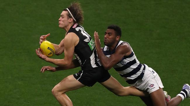 Darcy Moore marks in front of Geelong’s Esava Ratugolea.