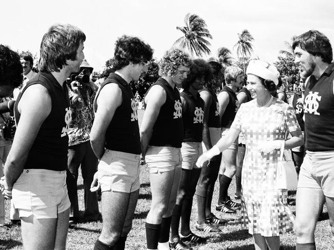 The Queen meets St Mary's footballers at Gardens Oval, escorted by club legend Vic Ludwig. Picture: NT News.