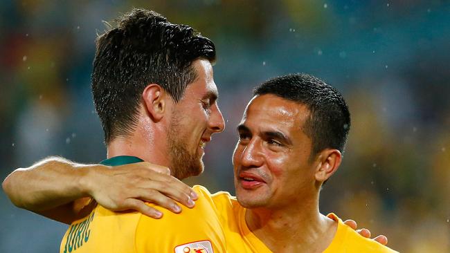 SYDNEY, AUSTRALIA - JANUARY 13: Tomi Juric of Australia is congratulated by teammate Tim Cahill after the 2015 Asian Cup match between Oman and Australia at ANZ Stadium on January 13, 2015 in Sydney, Australia. (Photo by Daniel Munoz/Getty Images)