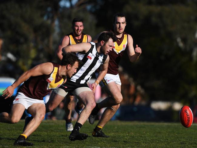 Nathan Hicks (2nd right) of Scoresby is seen in action qualifying final at East Burwood Reserve, Melbourne, Saturday, August 25, 2018. Scoresby v Boronia. (AAP Image/James Ross) NO ARCHIVING