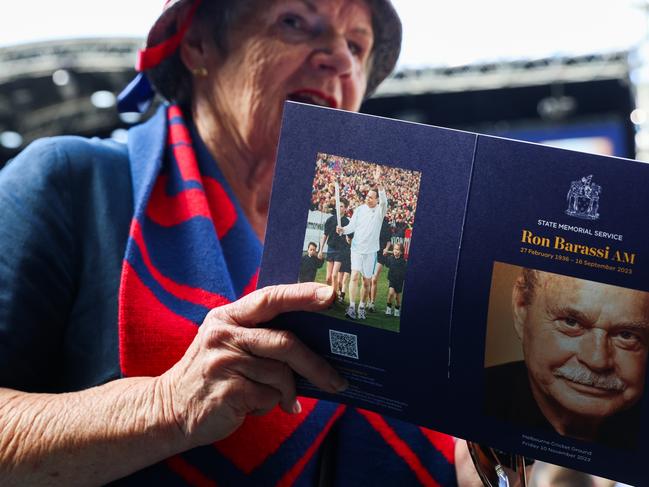 MELBOURNE, AUSTRALIA - NOVEMBER 10: A patron holding the memorial booklet during the Victoria State Memorial Service Held For Ron Barassi AM at Melbourne Cricket Ground on November 10, 2023 in Melbourne, Australia. Barassi, former VFL player, coach and media personality, passed away on 16th September.  (Photo by Asanka Ratnayake/Getty Images)