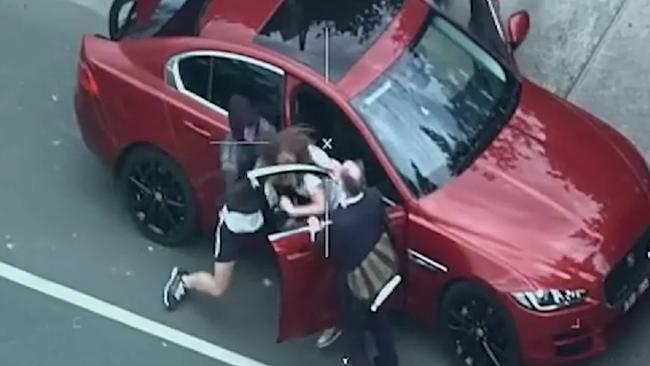 Police helicopter video footage showed McMillan grabbing a woman by her hair and throwing her to the ground to steal her car.