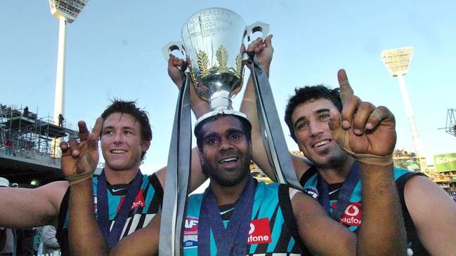 Roger James (R) with Byron Picket (C) and Stuart Dew (L) after winning the AFL premiership in 2004. Picture: Joe Castro