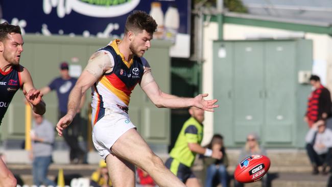 Adelaide's Bryce Gibbs kicks clear under pressure at Norwood Oval. Picture: AAP Image/Russell Millard