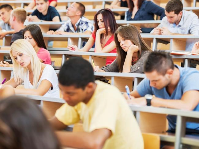 RendezView. Group of college students in the university amphitheatre, they are sitting and doing an exam. (Pic: iStock)