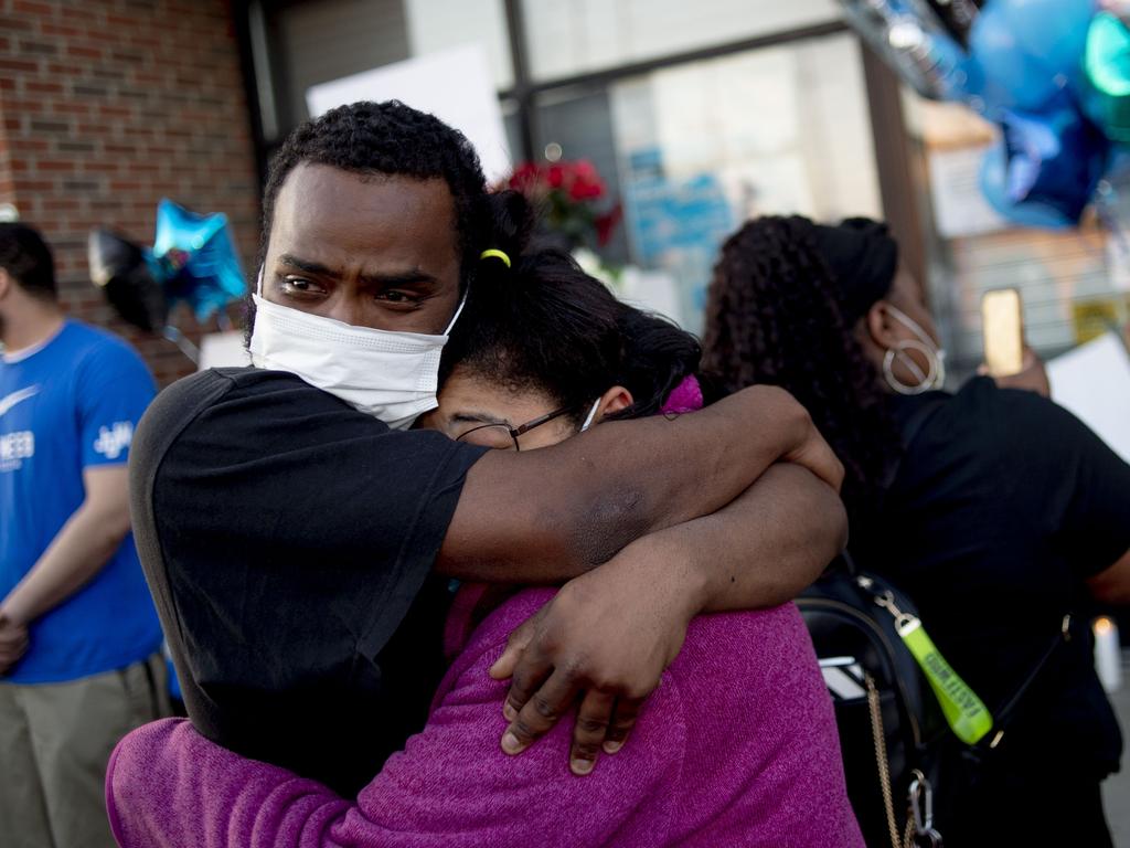 Deomnte Munerlyn, the firstborn son of Calvin, holds his aunt Sharion Munerlyn after news of the security guard’s death. Picture: Jake May/The Flint Journal-MLive.com via AP