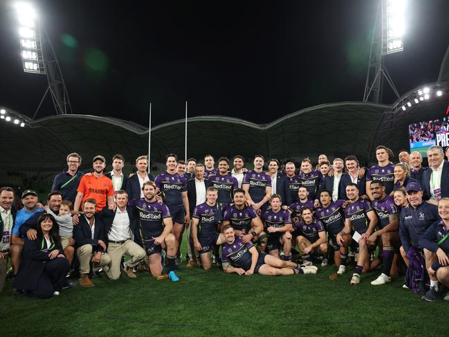 Storm players and staff pose for a photograph after being named 'minor premiers' after winning the round 25 NRL match against the Dolphins. Picture: Getty Images