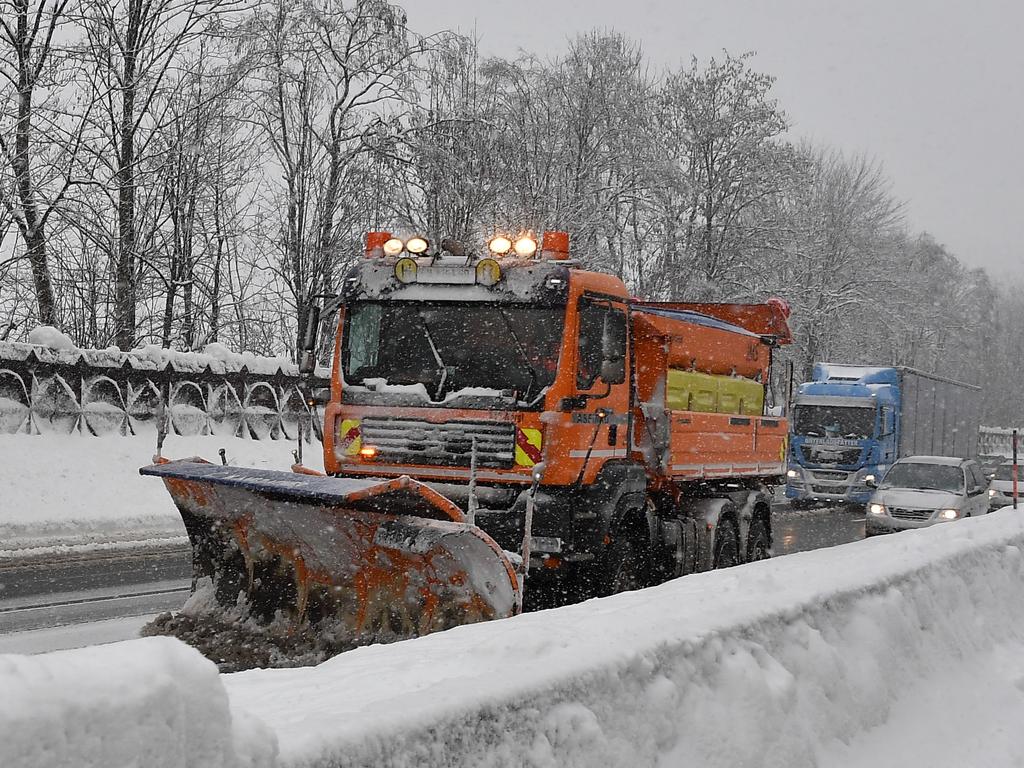 A snow plough truck makes its way on the highway near Kufstein after heavy snowfall in Austria. Picture: Joe Klamar/AFP