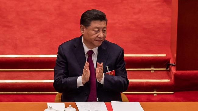 China's President Xi Jinping applauding after the result of the vote on changes to Hong Kong's election system was announced during the closing session of the National People’s Congress (NPC) at the Great Hall of the People in Beijing.