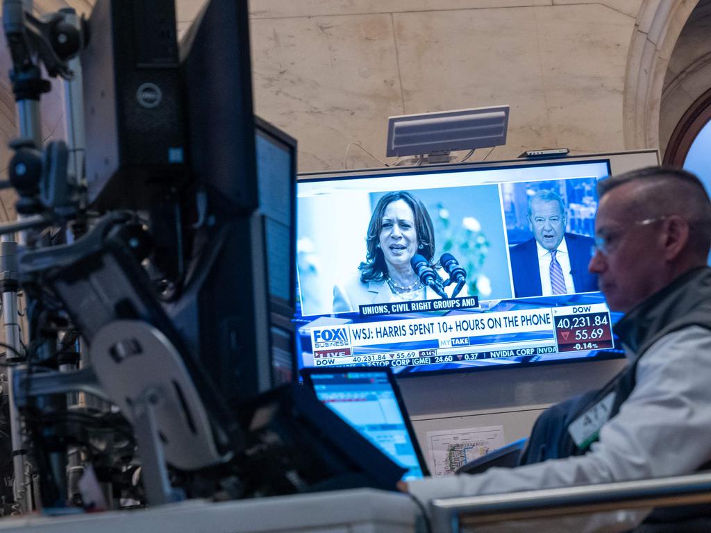 Traders work on the floor of the New York Stock Exchange (NYSE) as a picture of Vice President Kamala Harris is displayed on a television screen and market volatility increased. Picture: Getty Images via AFP