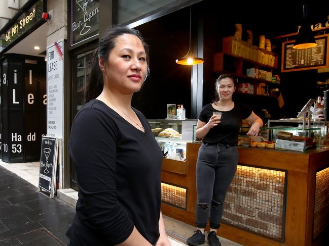 Budget 2020: Mia and Co Cafe owner Julie Marino (L) is hoping Jobkeeper will be extended to help pay the wages of her employees including staff member Jo Bui (back) pictured at their CBD premises on Pitt St. Picture: Toby Zerna