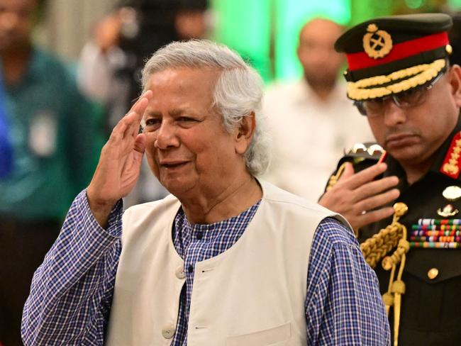 TOPSHOT - Nobel Peace Prize winner Muhammad Yunus (L) is sworn into office to lead Bangladesh's interim government as its chief adviser, days after a student-led uprising ended the 15-year rule of Sheikh Hasina, in Dhaka on August 8, 2024. (Photo by MUNIR UZ ZAMAN / AFP)