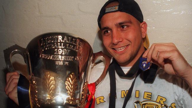 Adelaide Crows star Andrew McLeod with the 1997 premiership cup and Norm Smith Medal. Picture: Dodd Karen