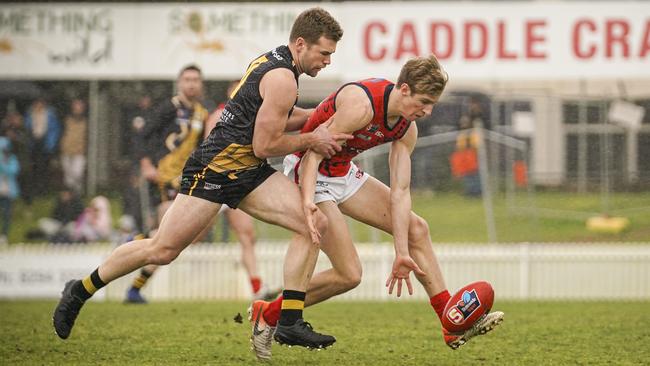 Dylan Stephens competes for the ball with Glenelg’s Andrew Bradley. Picture: MIKE BURTON/AAP