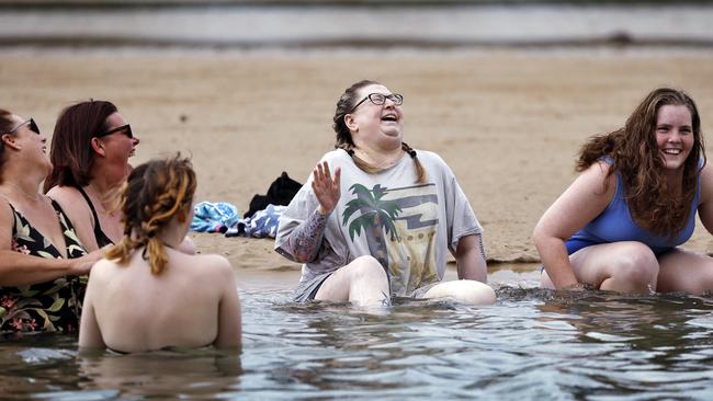 Kay Henderson (grey T-shirt) shared laughs and hugs with family and friends during her final swim at Coffs Harbour. Picture: Sam Ruttyn