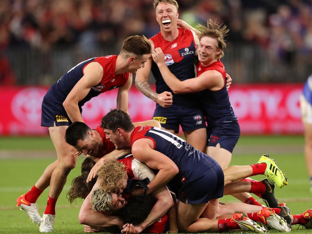 The Melbourne Demons pile on each other after the final siren. Picture: Will Russell/AFL Photos via Getty Images