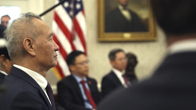 Chinese Vice Premier Liu He listens during a meeting with President Donald Trump.