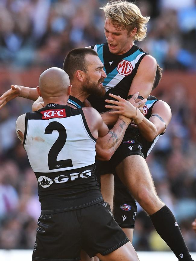 Jason Horne-Francis celebrates a Port Adelaide goal with Charlie Dixon and Sam Powell-Pepper.