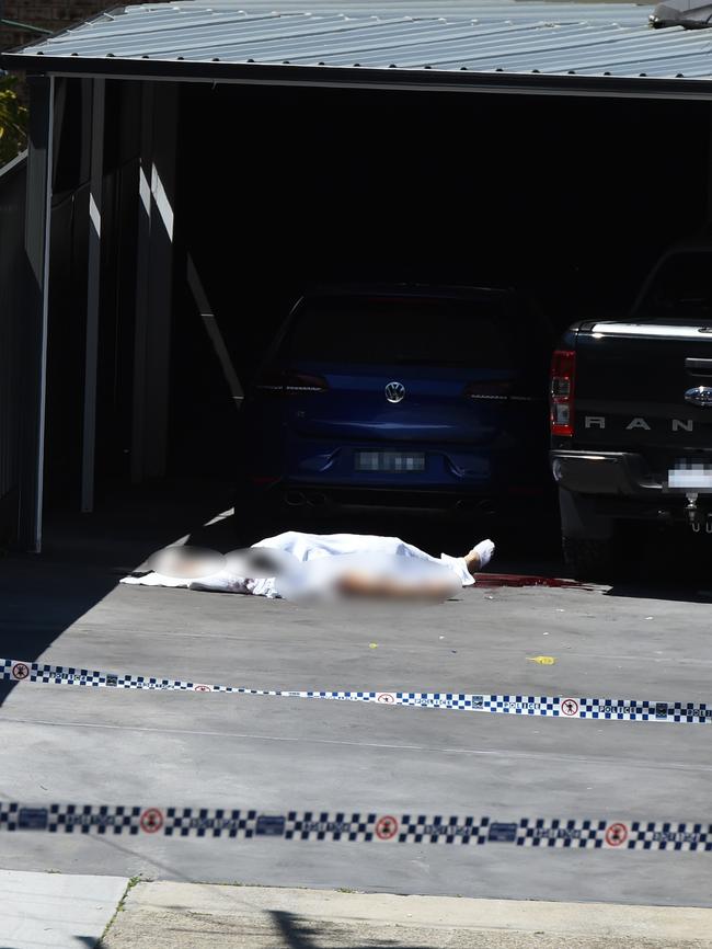 Assaad’s body is covered by a white sheet on the driveway where he was shot dead.
