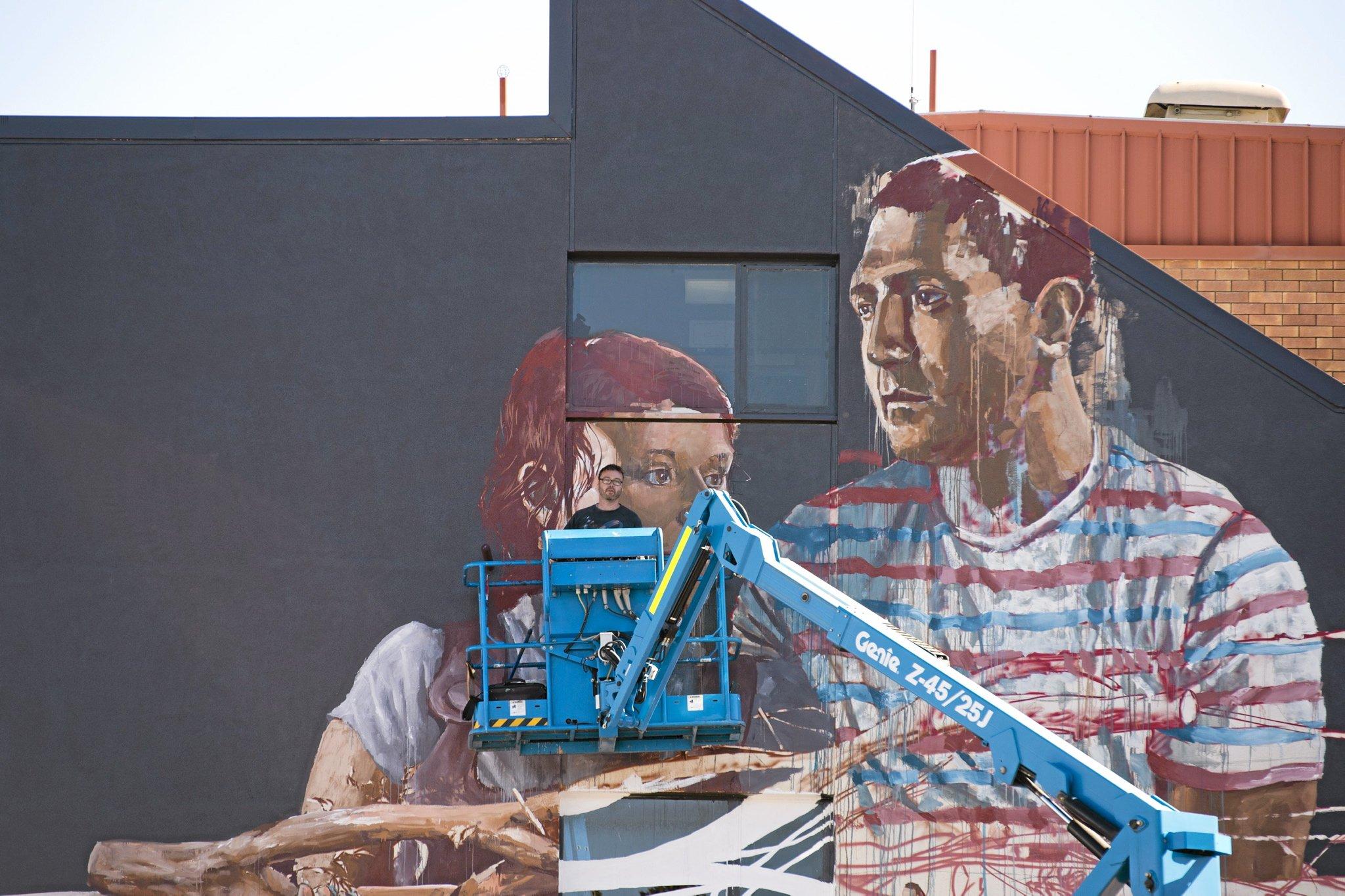 Fintan Magee paints on the SES building wall in Hume St car park for First Coat, Monday, May 30, 2016. Picture: Kevin Farmer