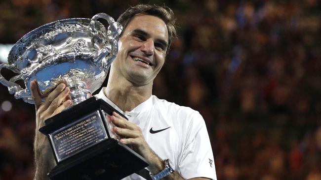 Roger Federer holds his Australian Open trophy in 2018. Picture: AP Photo/Dita Alangkara, File