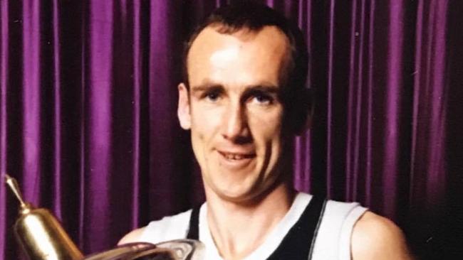 Brunswick great Barry Nolan with the VFA premiership trophy.