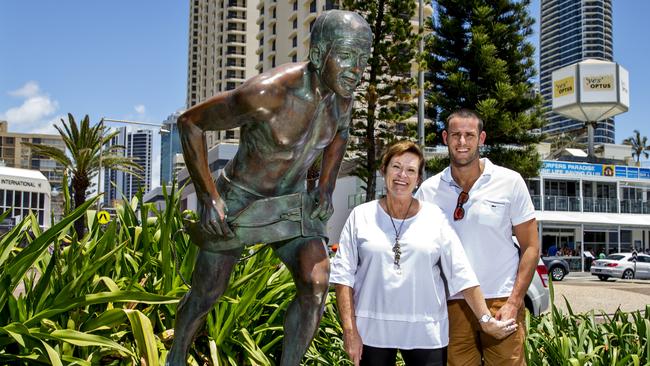 Ann Lacey and son Adam with the Surfers Paradise statue of their legendary husband and father, Peter Lacey, who died 20 years ago today. Photo: Jerad Williams