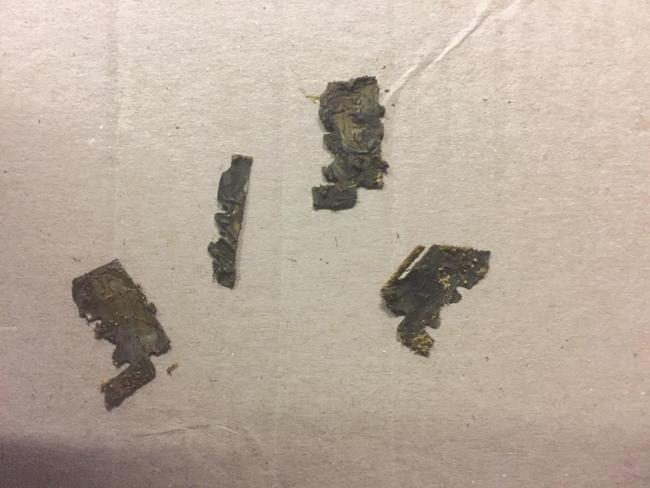 The fragments of razor blades discovered in Zeus’s excrement. Luckily, he was unharmed despite the attack.