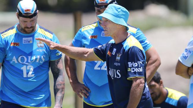 Gold Coast coach Neil Henry speaks to the players.