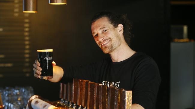 Shambles Brewery’s bar keep Will Caugh serves up one of Tassie’s finest winter brews the Barry White Robust Porter, 6% ABV, which sells for $13 for a pint. Picture: MATT THOMPSON