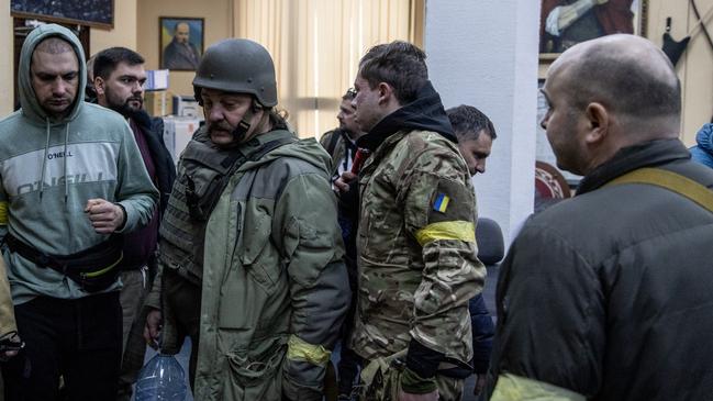 Civilian volunteers gather at a Territorial Defence unit registration office in Kyiv, Ukraine. Picture: Getty Images