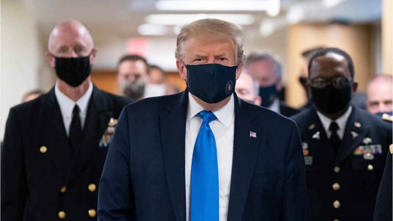 US President Donald Trump wears a mask in public for the first time