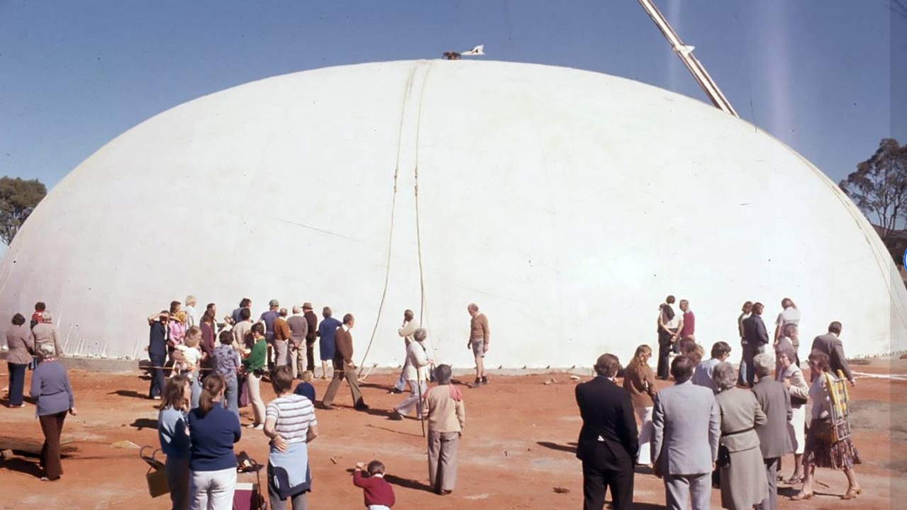 Dignitaries and onlookers watch th giant balloon inflate.