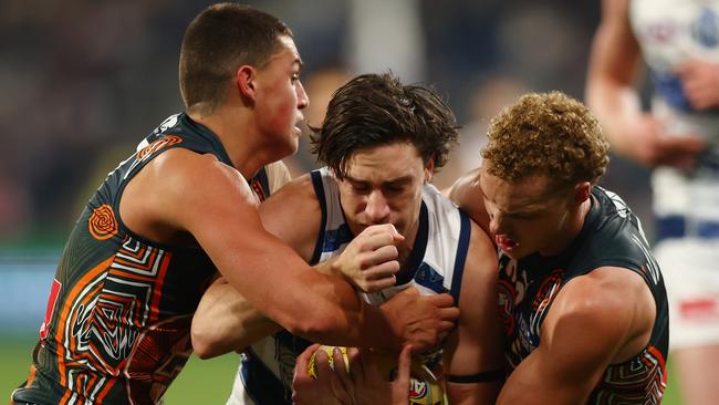 GEELONG, AUSTRALIA - MAY 25:  Gryan Miers of the Cats is tackled during the round 11 AFL match between Geelong Cats and Greater Western Sydney Giants at GMHBA Stadium on May 25, 2024 in Geelong, Australia. (Photo by Graham Denholm/Getty Images)