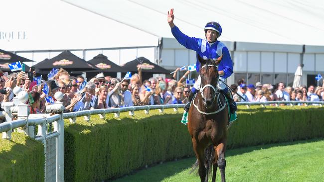 Jockey Hugh Bowman salutes the crowd after Winx put on another stunning show for her fans in the Chipping Norton Stakes. Picture: AAP