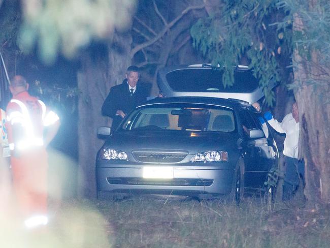 Coronial services and detectives load a vehicle near Mt Macedon. Picture: Mark Stewart