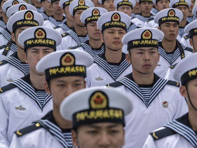 QINGDAO, CHINA - APRIL 21: Chinese sailors sit together  after performing signals with flags at a demonstration during a media tour of an open house at the PLA Navys Submarine Academy as part of events marking the 75th Anniversary of the founding of the countrys navy on April 21, 2024 in Qingdao, China. China is hosting the Western Pacific Naval Symposium this week. (Photo by Kevin Frayer/Getty Images)