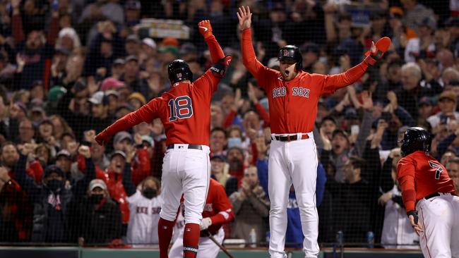 BOSTON, MASSACHUSETTS - OCTOBER 18: Kyle Schwarber #18 of the Boston Red Sox celebrates with Christian Arroyo #39 after Schwarber hit a grand slam home run against the Houston Astros in the second inning of Game Three of the American League Championship Series at Fenway Park on October 18, 2021 in Boston, Massachusetts. (Photo by Elsa/Getty Images)