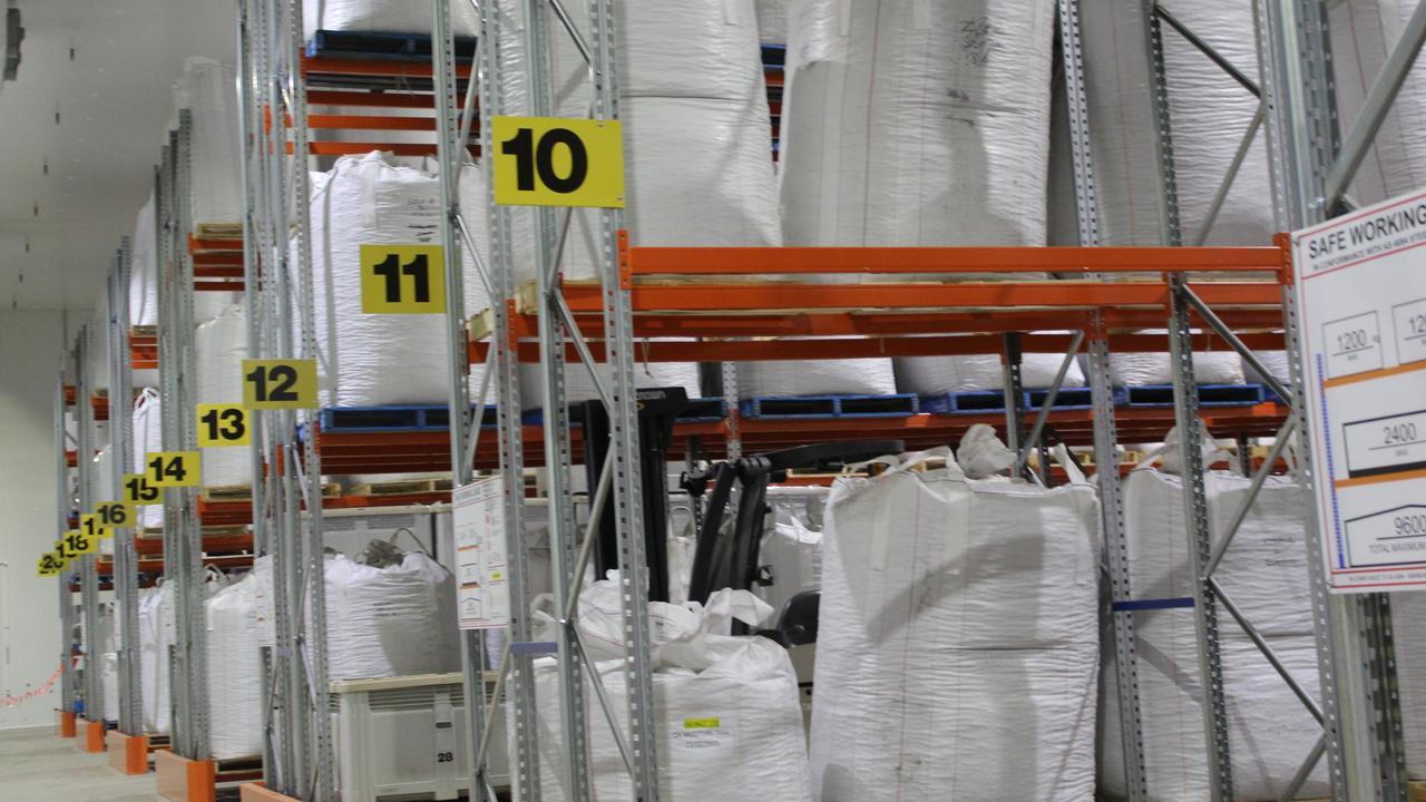 Bags of macadamia nuts in shell waiting to be processed.