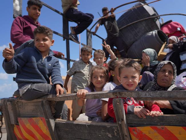 Displaced Palestinians arrive with their belongings to set up tents on a beach, near Deir el-Balah, in the central Gaza Strip. Picture: AFP