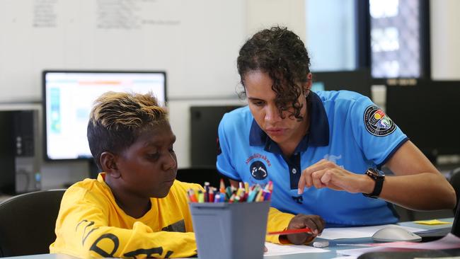 Azariah Mamarika, 14, of Groote Eylandt studies with AFL Cape York House tutor Shirlee Webb. Picture: Brendan Radke