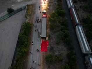 SAN ANTONIO, TX - JUNE 27: In this aerial view, members of law enforcement investigate a tractor trailer on June 27, 2022 in San Antonio, Texas. According to reports, at least 46 people, who are believed migrant workers from Mexico, were found dead in an abandoned tractor trailer. Over a dozen victims were found alive, suffering from heat stroke and taken to local hospitals.   Jordan Vonderhaar/Getty Images/AFP (Photo by Jordan Vonderhaar / GETTY IMAGES NORTH AMERICA / Getty Images via AFP)