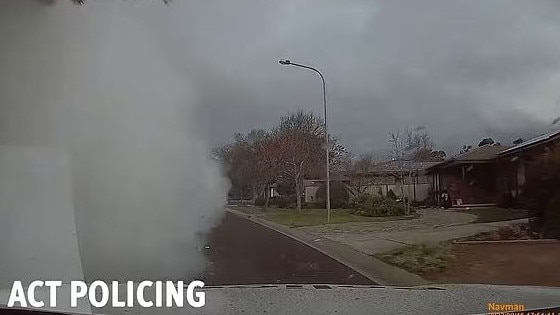 A driver does a burnout in front of police car. Picture: ACT Policing