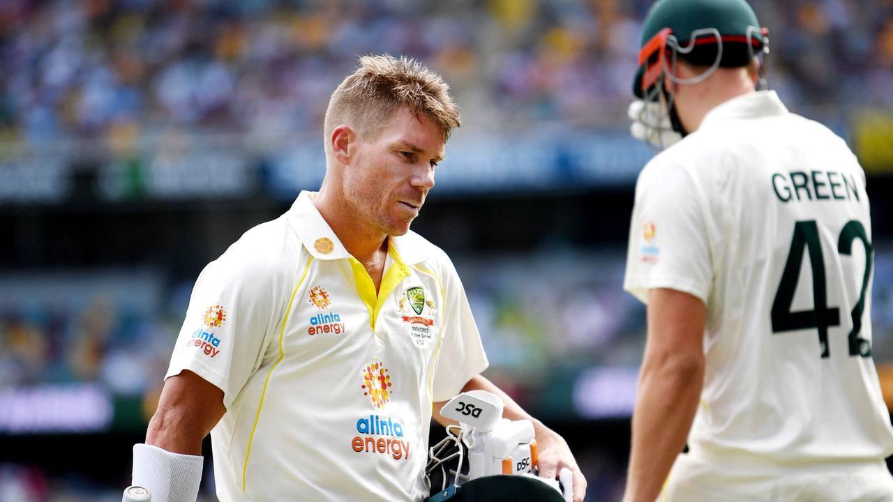 David Warner of Australia (L) walks off the field after he was dismissed. Photo by Dan PELED / AFP