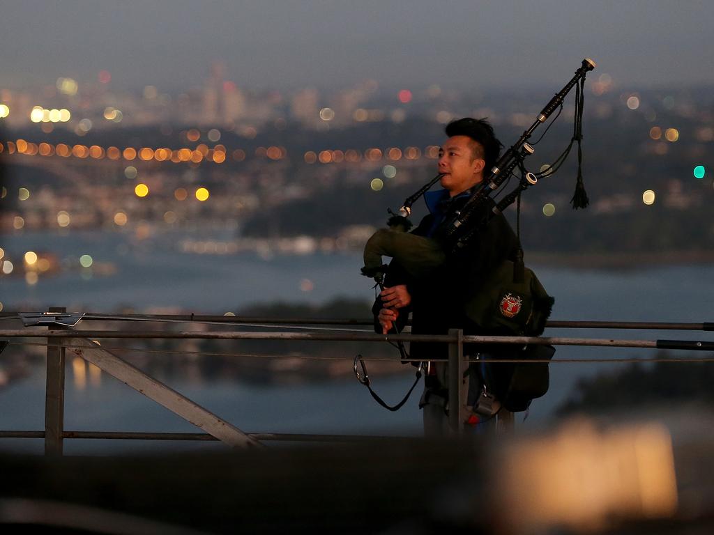 A dawn service was held on the summit of the Sydney Harbour Bridge to commemorate ANZAC Day. Money raised by the members of the public who climbed the bridge went to RSL DefenceCare. Bagpiper Ricky Keung. Picture: Toby Zerna