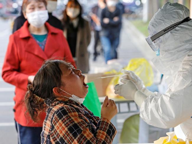 Companies, schools and individuals across China are lining up to be tested for the virus as the country rises back to normal life. Picture: AFP