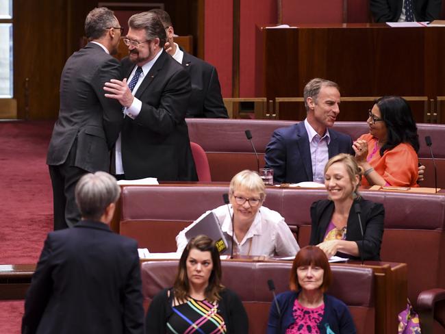 Senator Derryn Hinch is congratulated by Australian Greens Senator Richard Di Natale after the passing of the Medevac Bill on Wednesday. Picture: AAP