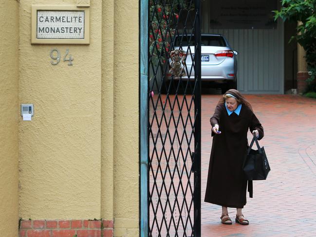 7/04/20 A nun closes the front gate of the Carmelite Monastery in Kew, believed to be where George Pell is hiding out after his release from Barwon Prison.  Aaron Francis/The Australian