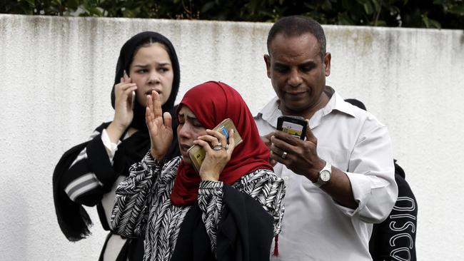 People speak on their phones outside the Masjid Al Noor mosque in Christchurch. Picture: AP